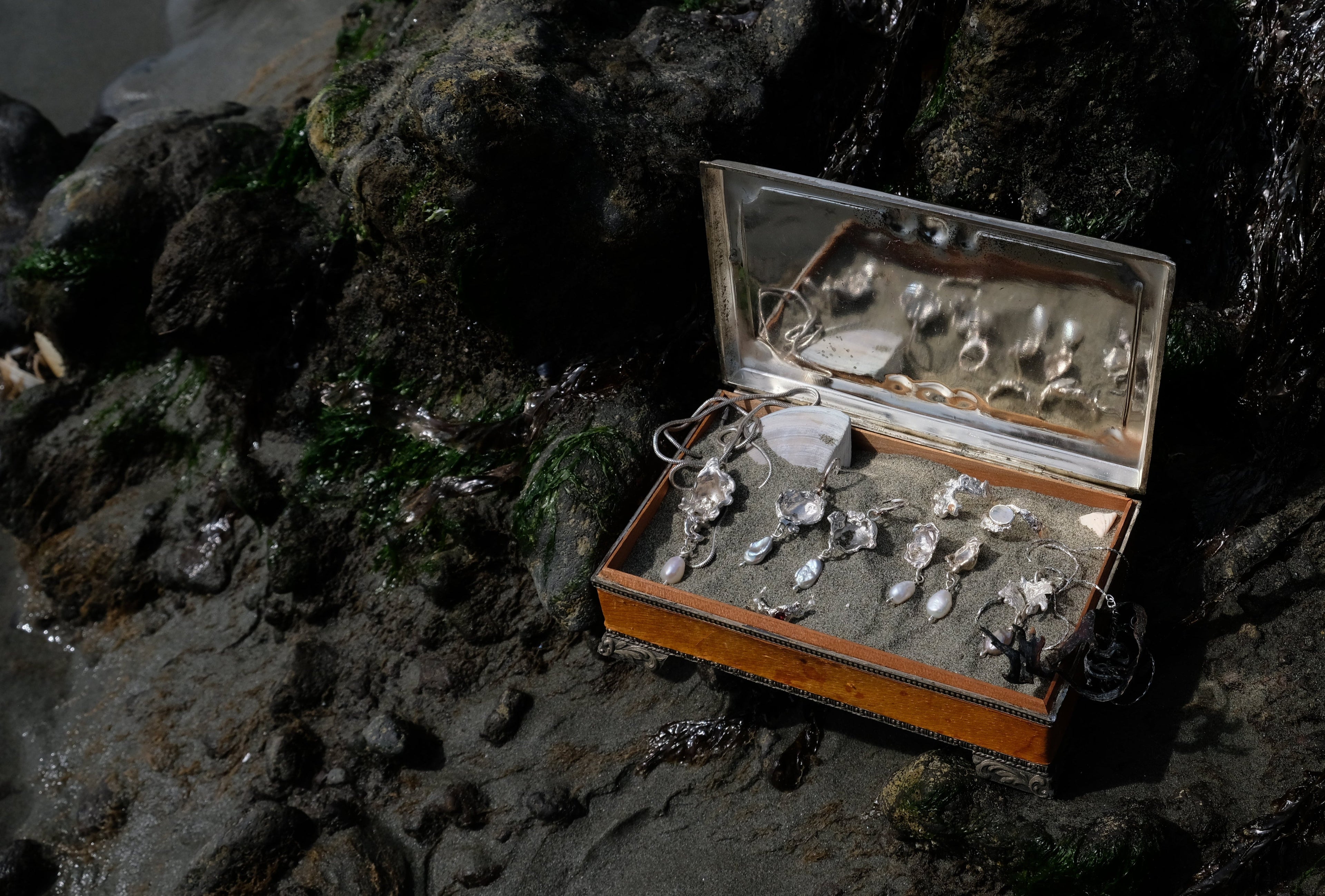 Silver and pearl jewellery in vintage jewellery box by a rockpool | Made with Grace | handmade jewellery nz
